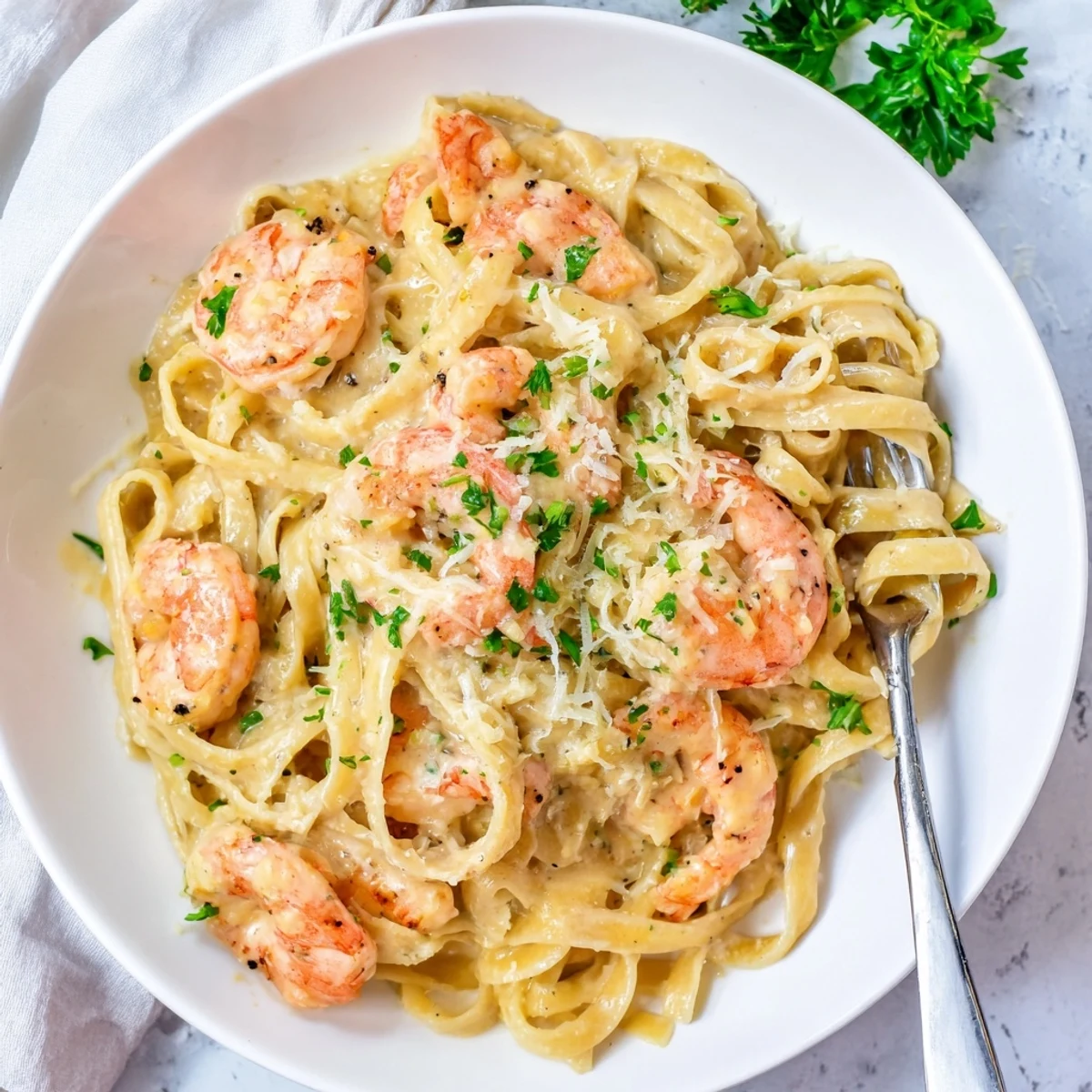 Creamy one pan shrimp fettuccine alfredo with tender pink shrimp twirled in rich parmesan garlic sauce