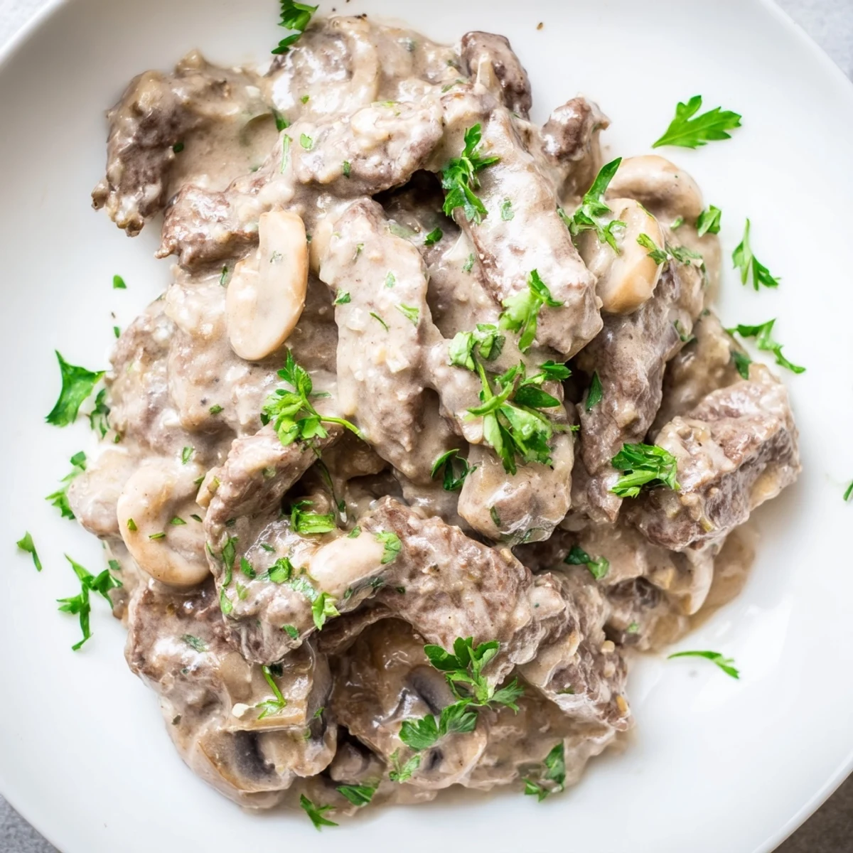 Classic Russian beef stroganoff with golden mushrooms and tender beef nestled on a bed of egg noodles