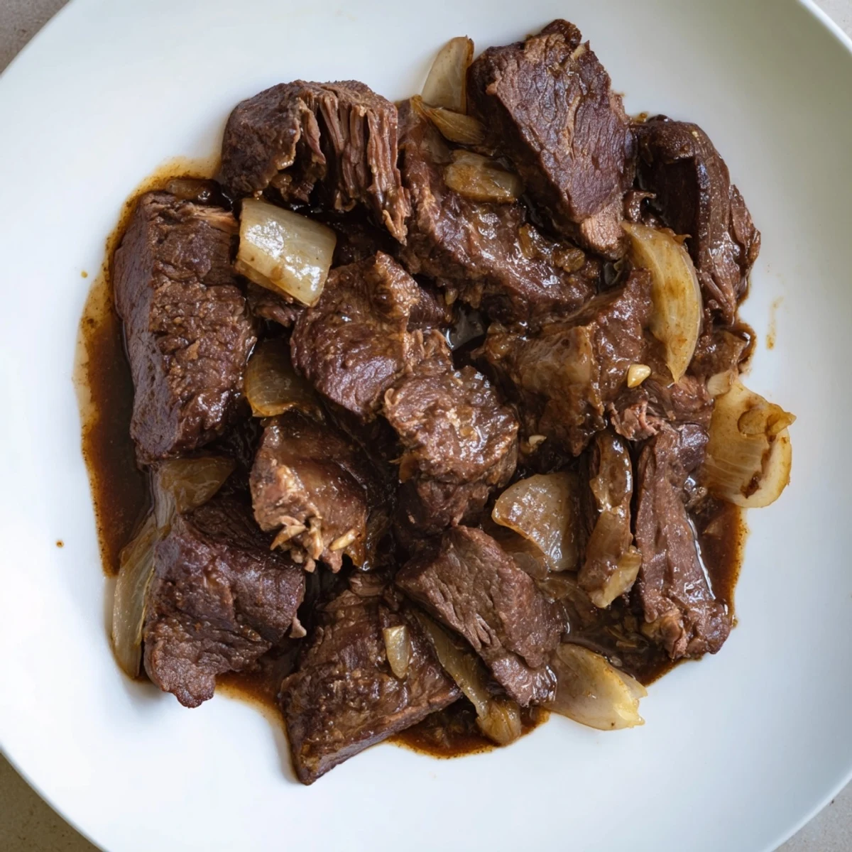 Fork-tender Crock Pot shredded beef shredded and ready for tacos or sandwiches
