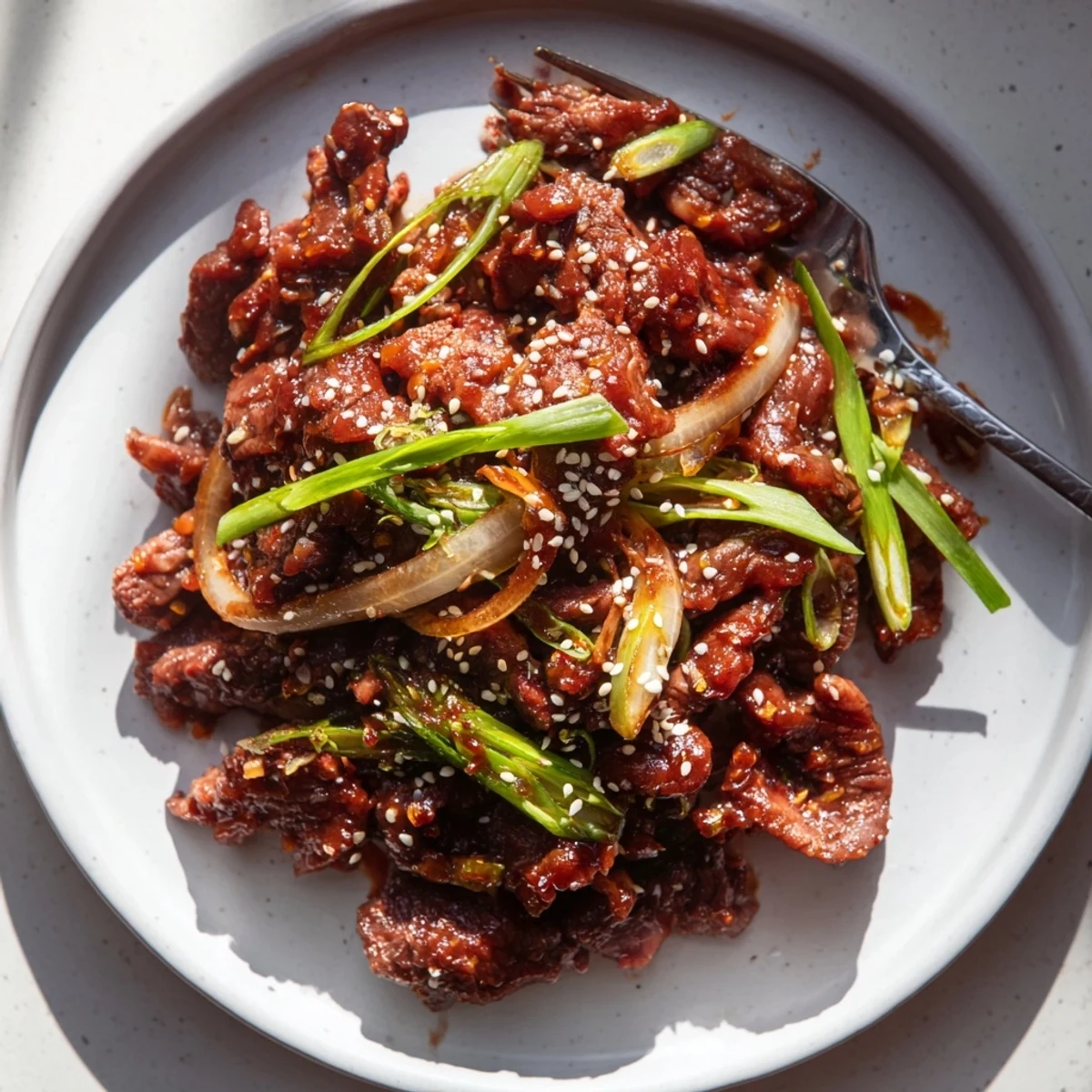 Fork-tender slow cooker Korean beef coated in glossy soy ginger sauce ready for lettuce wraps