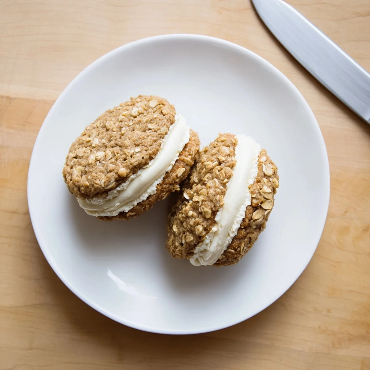 Close-up of homemade oatmeal cream pies showing chewy texture and fluffy white cream filling