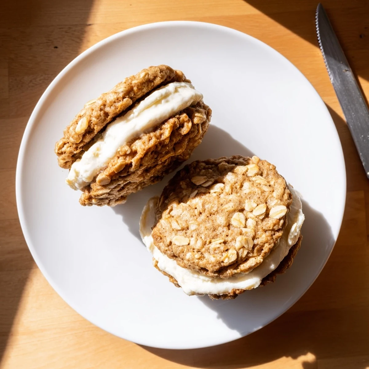 Plate of golden-brown homemade oatmeal cream pies sandwiched with sweet vanilla cream filling