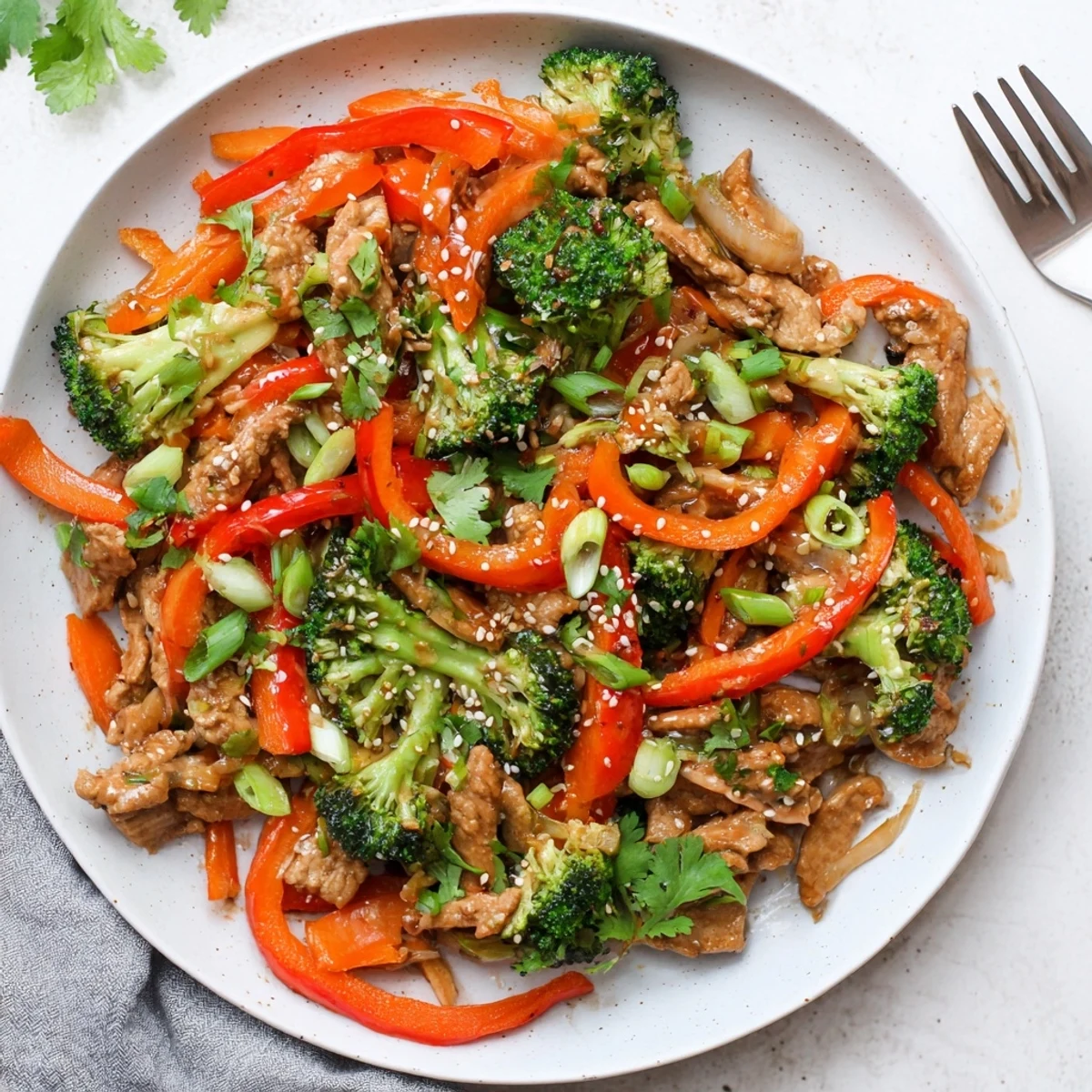 Golden brown ground turkey stir fry with broccoli and colorful vegetables in savory glossy sauce