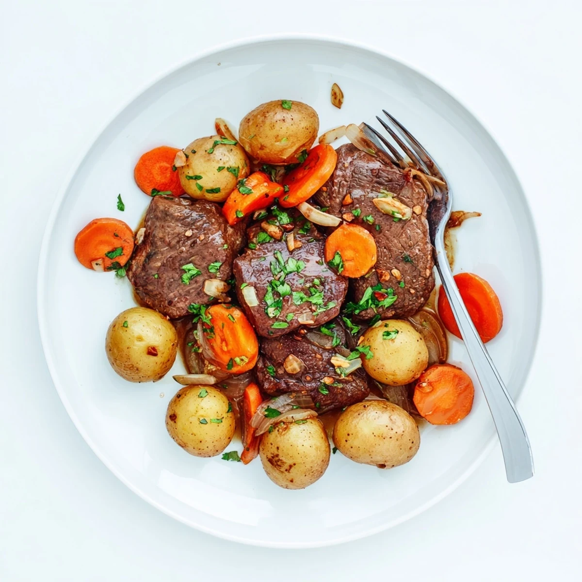 Golden brown seared beef steaks nestled alongside tender baby potatoes in slow cooker steak and potatoes