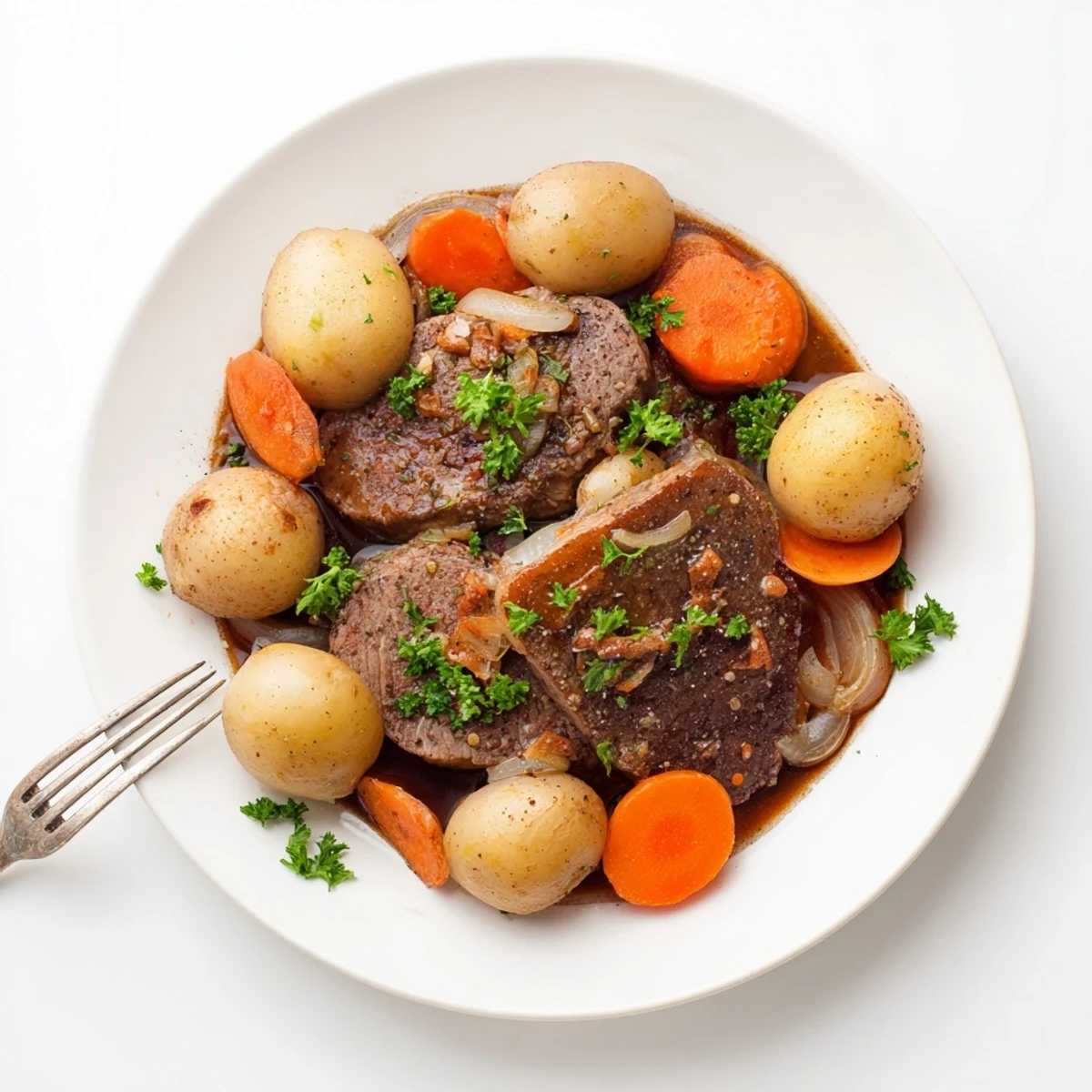 Savory slow cooker steak and potatoes featuring buttery carrots and onions in rich beef broth