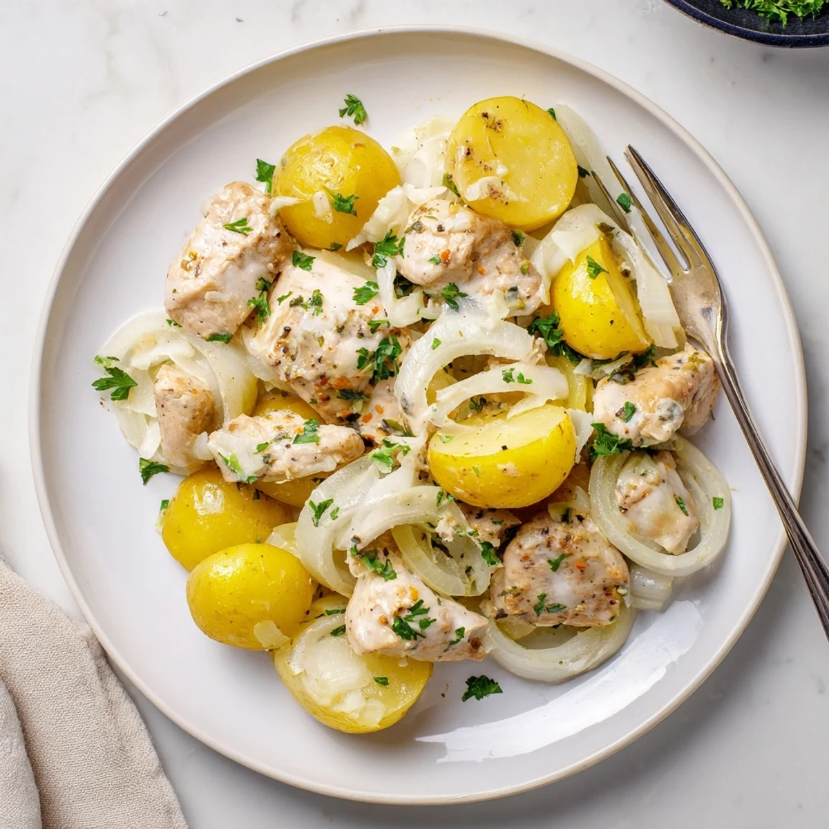 Hearty one-pot meal featuring juicy chicken breasts, baby potatoes, and savory parmesan garlic sauce