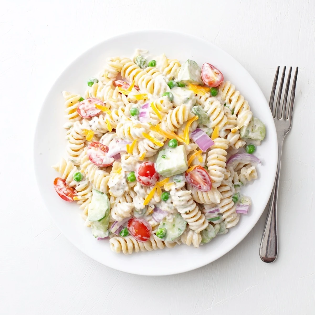 Chilled creamy ranch pasta salad featuring rotini tomatoes cucumber and bell pepper