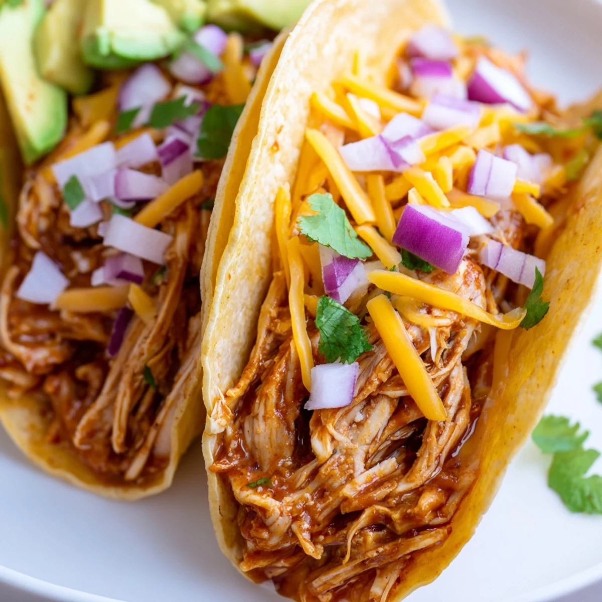 Juicy slow cooker shredded chicken tacos loaded with fresh toppings in crispy corn shells