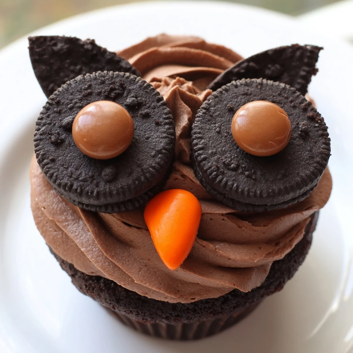 Frosted Oreo Owl Cupcakes decorated with candy beaks and Oreo cookie eyes served fresh