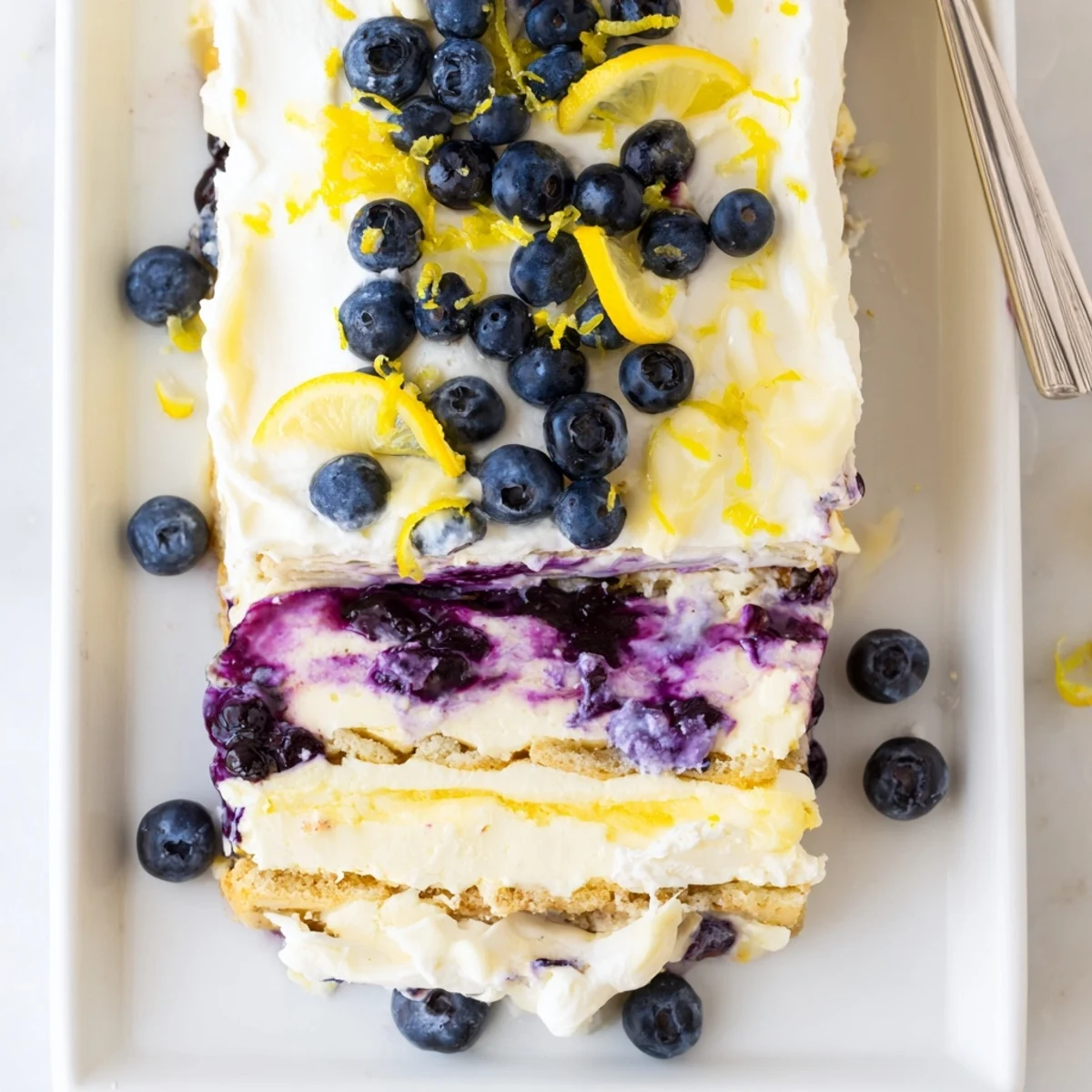 No-bake lemon blueberry lasagna with vibrant berry swirls and fluffy cream layers