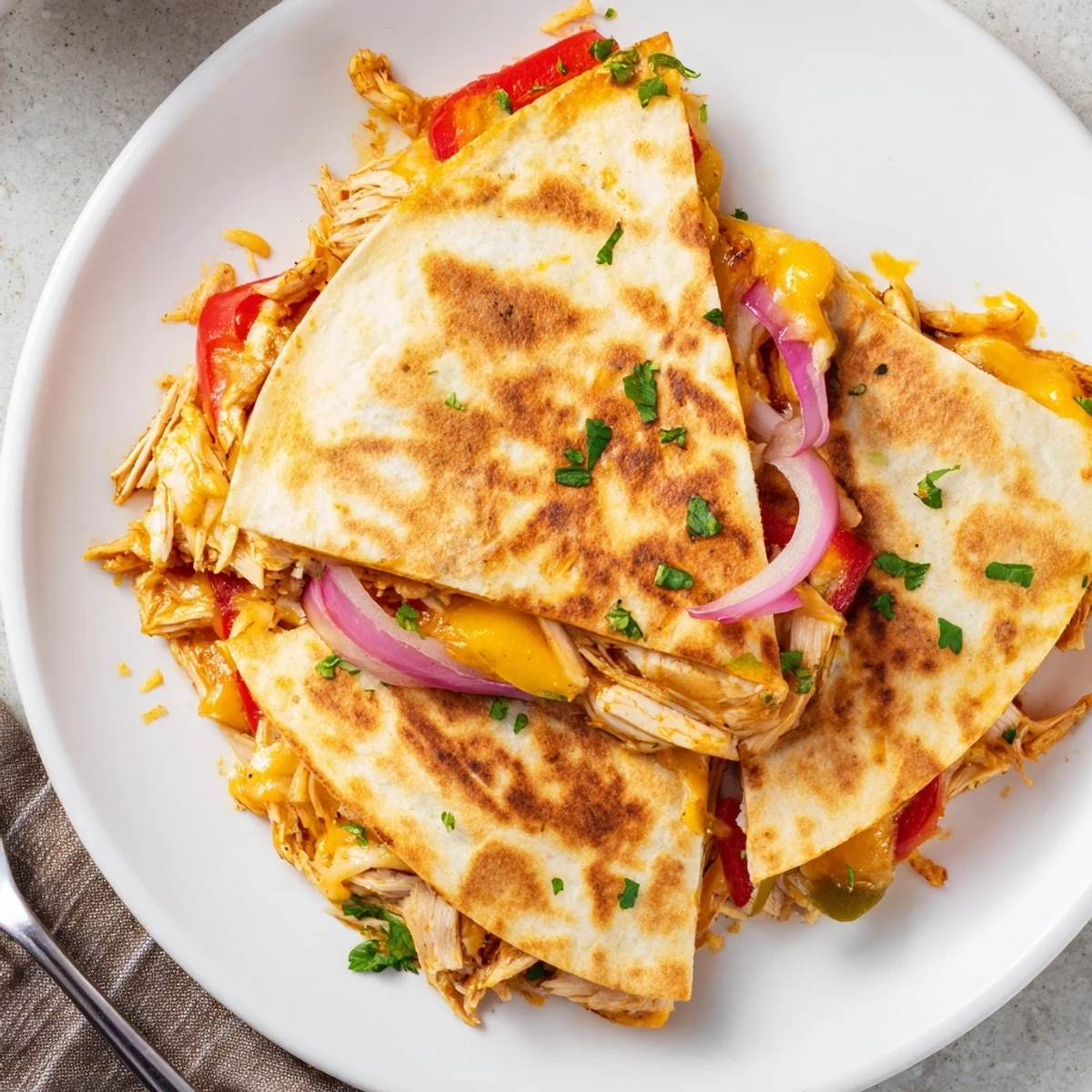 Charred pepper studded Spicy Crispy Grilled Chicken Quesadilla skillet grilled to buttery crisp
