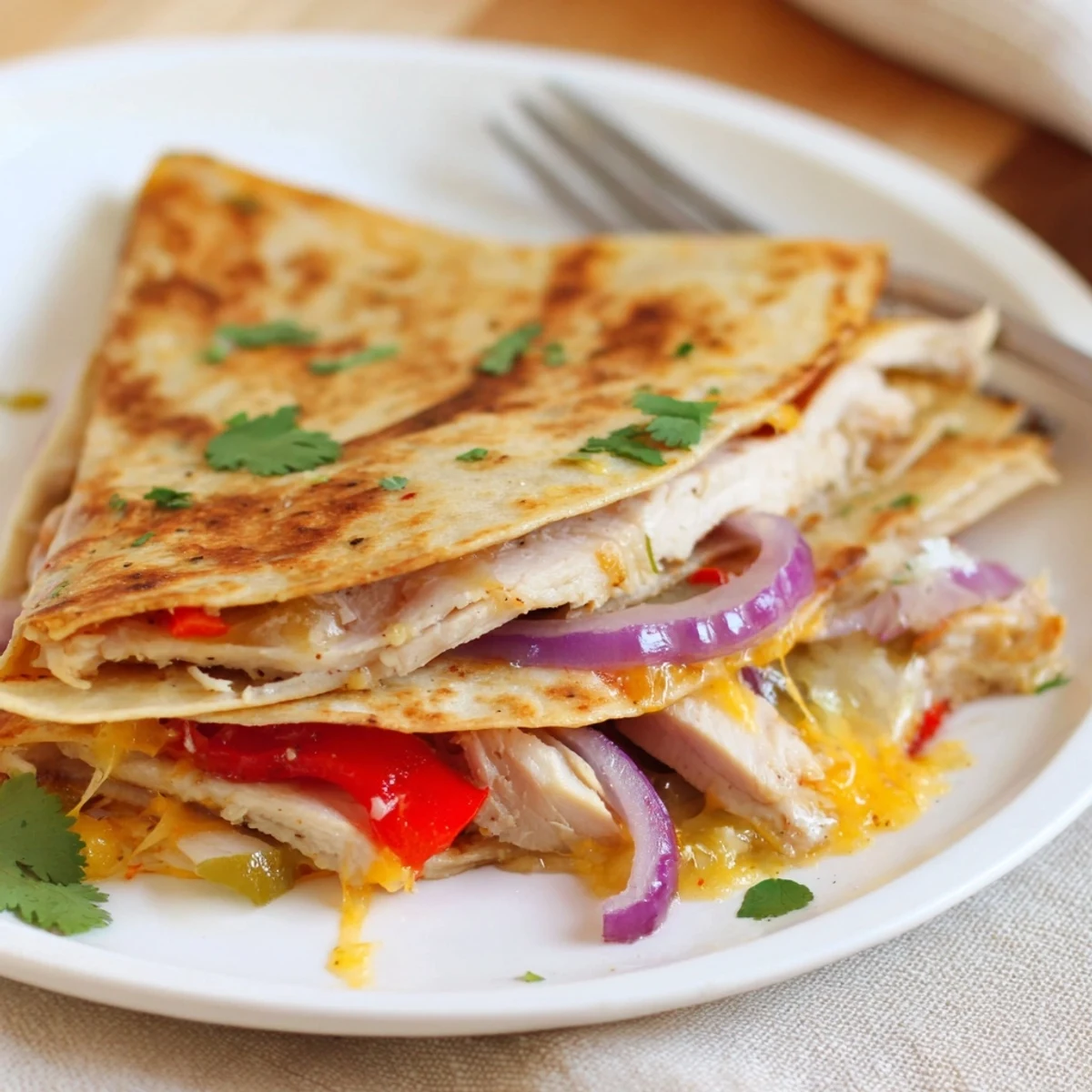 Aromatic Spicy Crispy Grilled Chicken Quesadilla sliced into wedges with guacamole