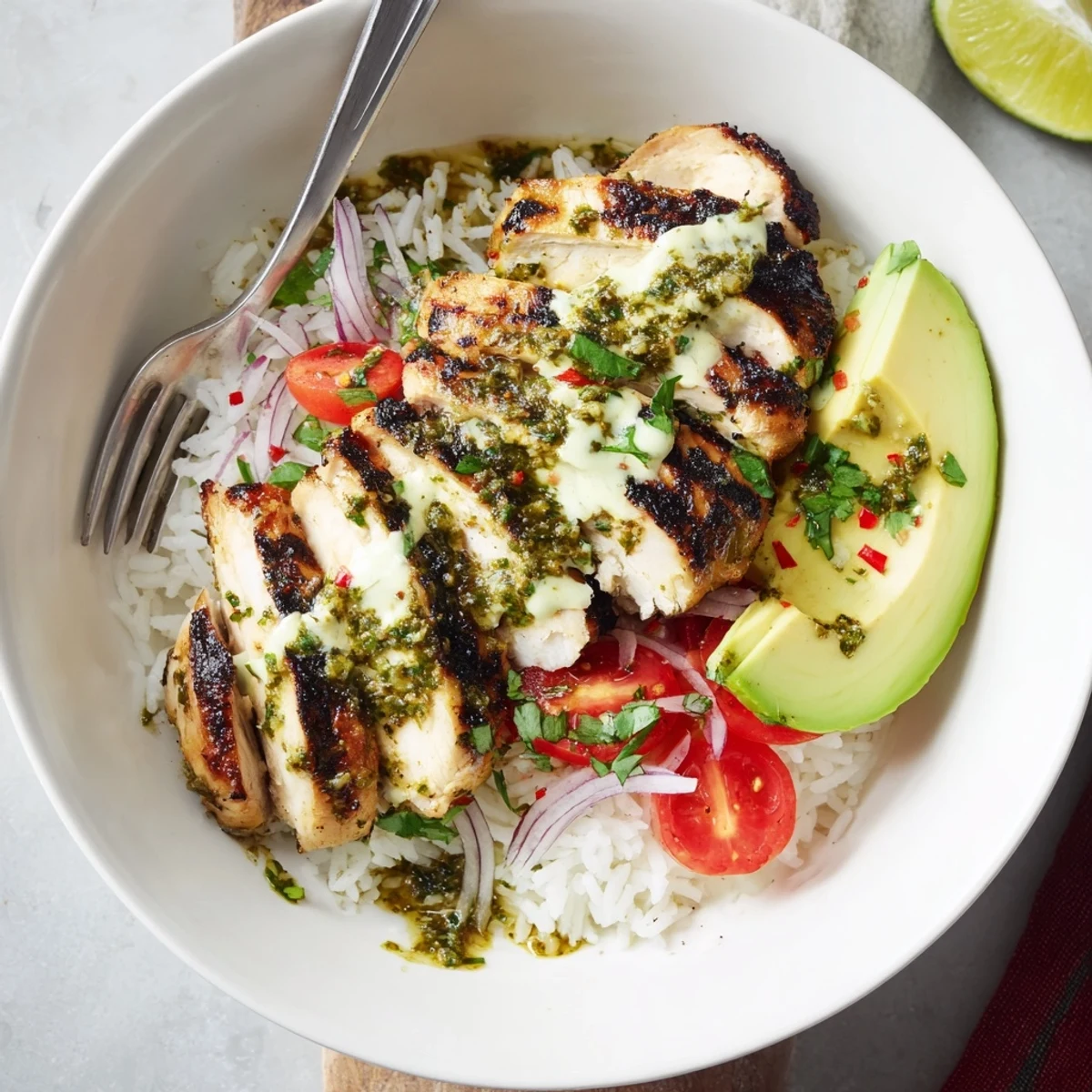 Chimichurri Grilled Chicken Bowl With Garlic Sauce drizzled, tangy lime wedge for serving