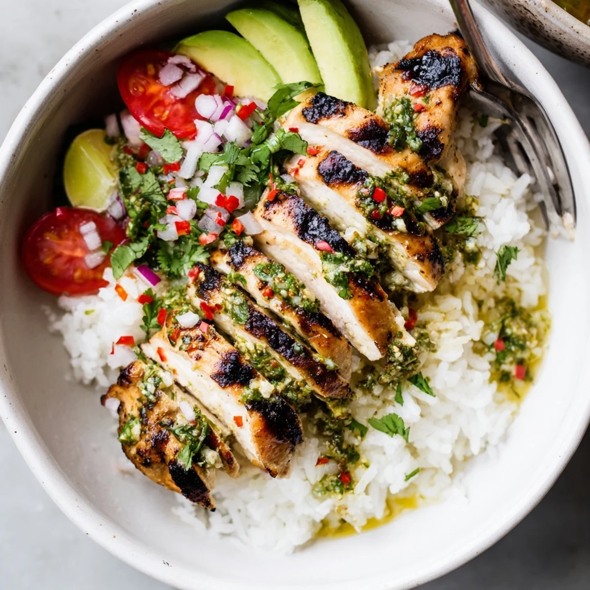 Sliced Chimichurri Grilled Chicken Bowl With Garlic Sauce, avocado, tomatoes, cilantro.