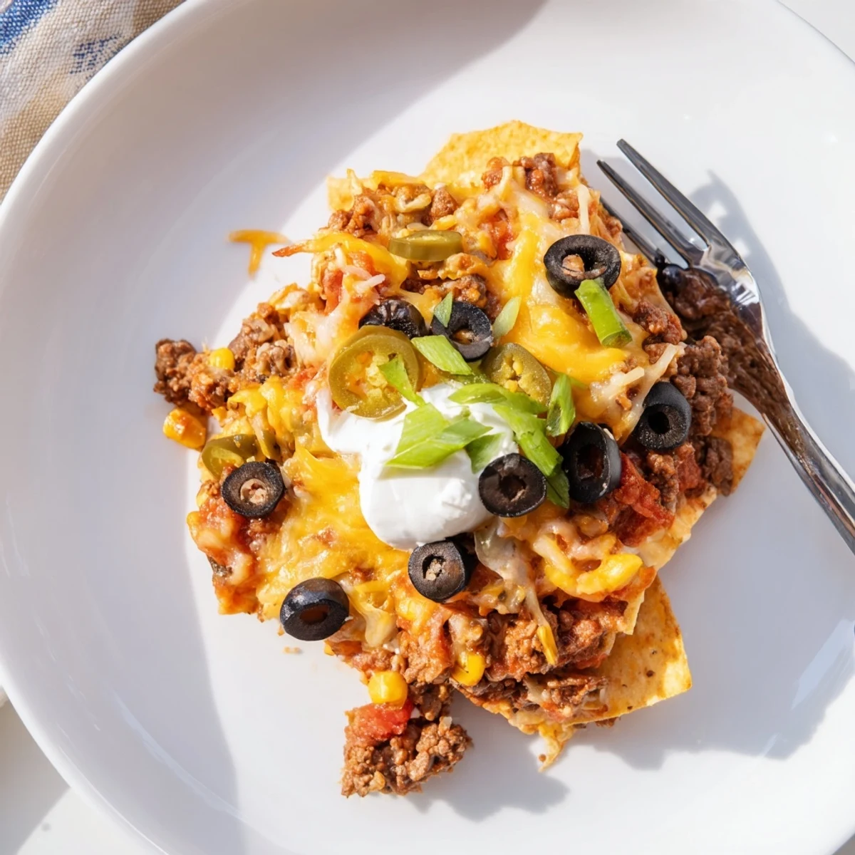 Family-style casserole: Cheesy Nacho Casserole served hot with sour cream and jalapenos.