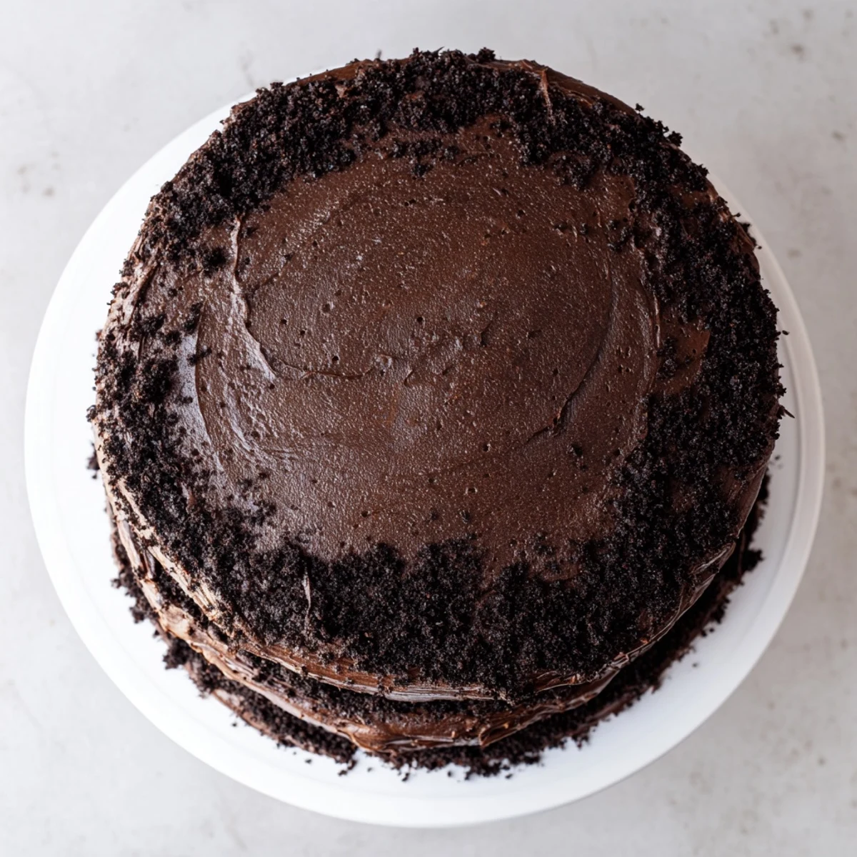 Moist chocolate cake slice revealing tender crumb topped with creamy buttercream frosting