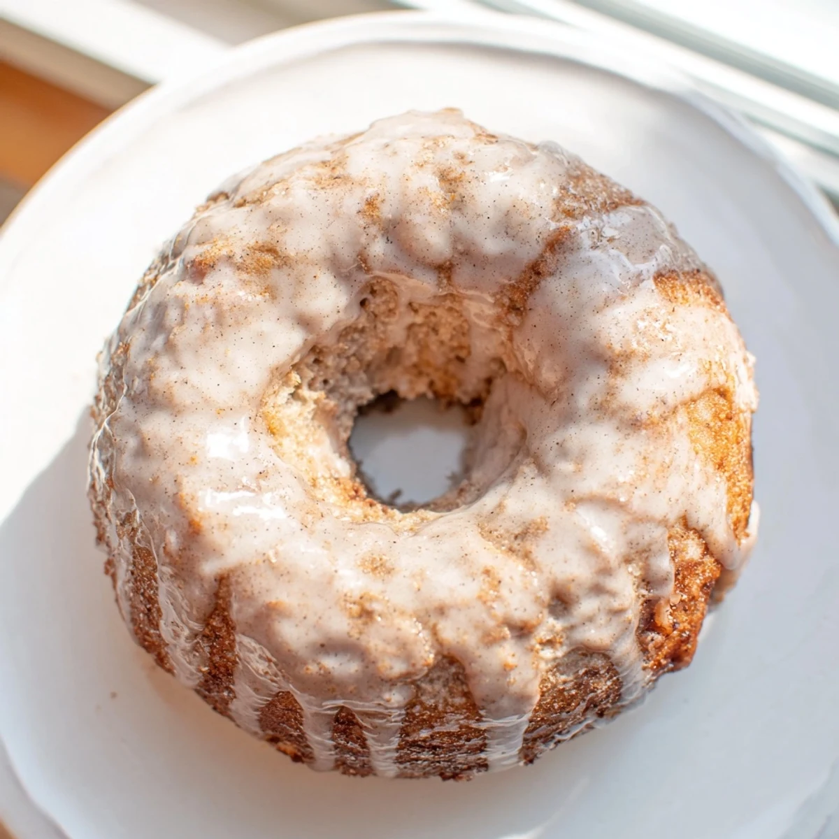 Soft moist banana bread donuts fresh from the oven with powdered sugar dusting