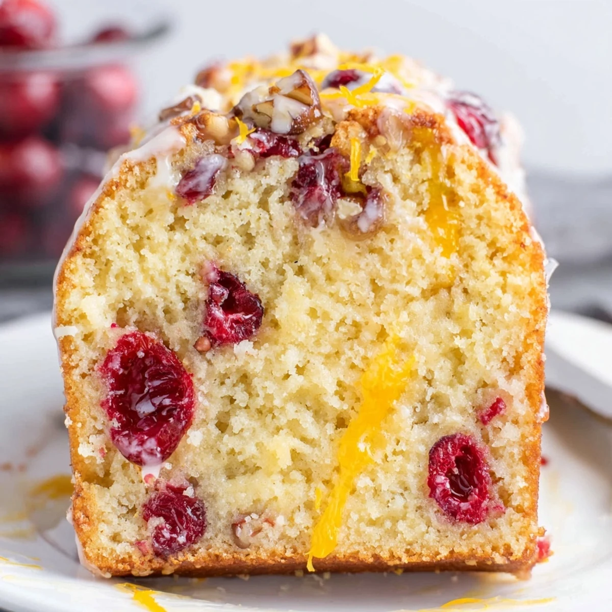 Sliced Cranberry Orange Bread with buttery crumb, served with steaming tea