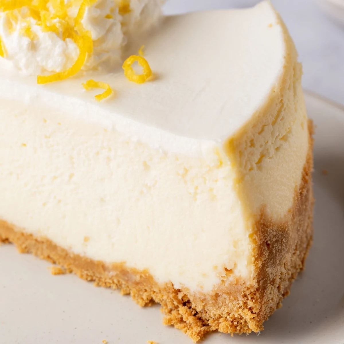 Creamy Classic Cheesecake served with whipped cream and toasted pecans.