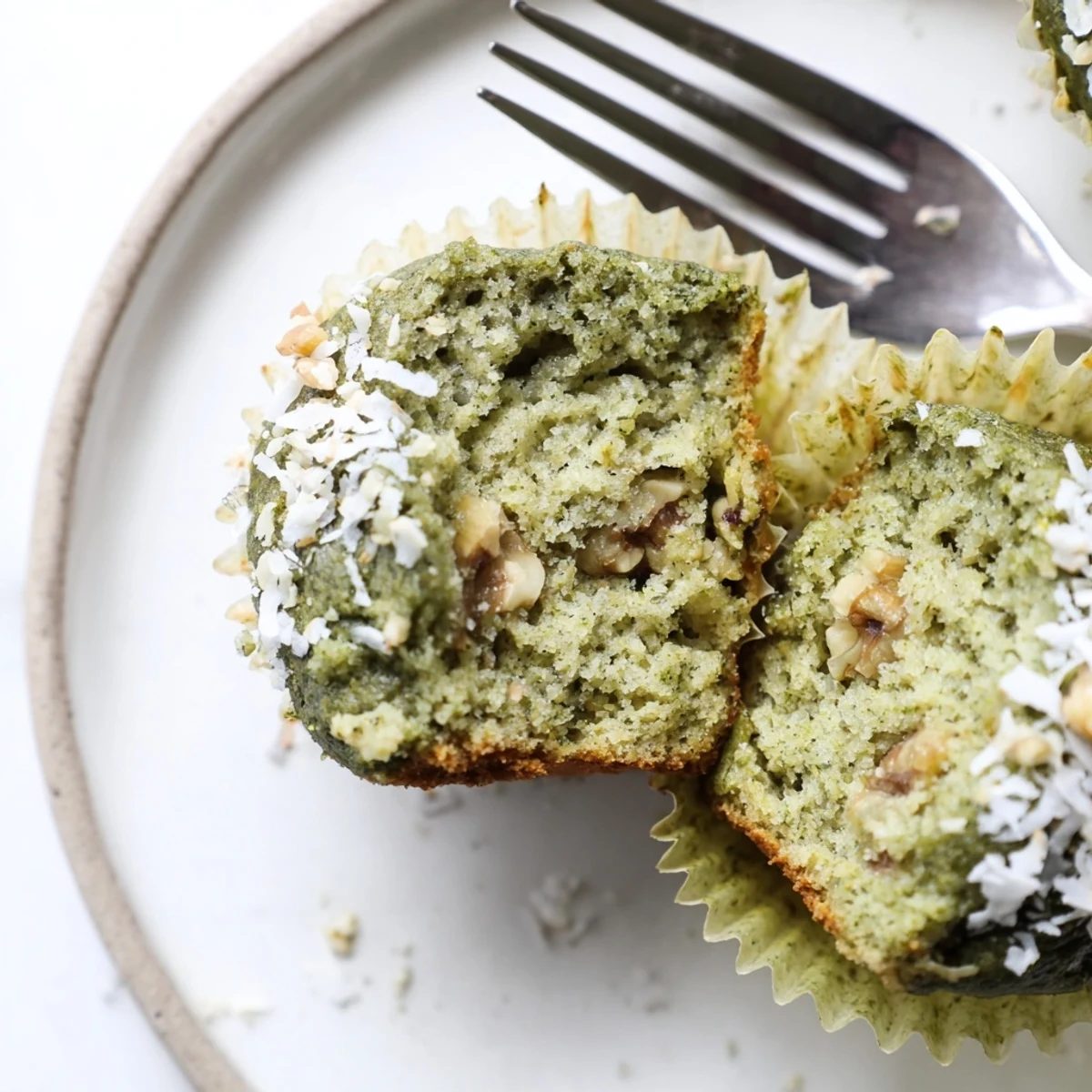 Freshly baked Matcha Banana Coconut Muffins cooling on rack, banana aroma.